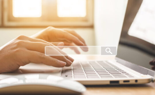 Searching information data on internet networking concept. Hand of male typing text on laptop keyboard