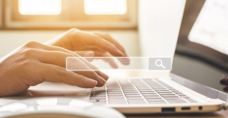 Searching information data on internet networking concept. Hand of male typing text on laptop keyboard