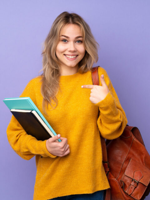 Teenager Russian student girl isolated on purple background with surprise facial expression